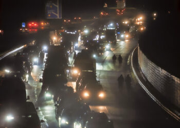 Motorists walking along carriageway