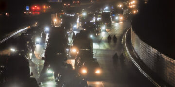 Motorists walking along carriageway